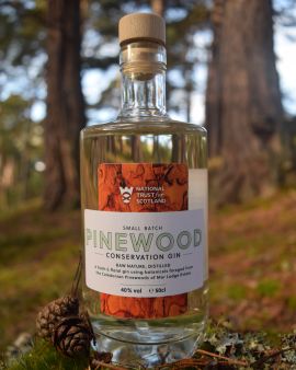 Close up of the front of Pinewood Conservation Gin bottle, in the Mar Lodge Estate